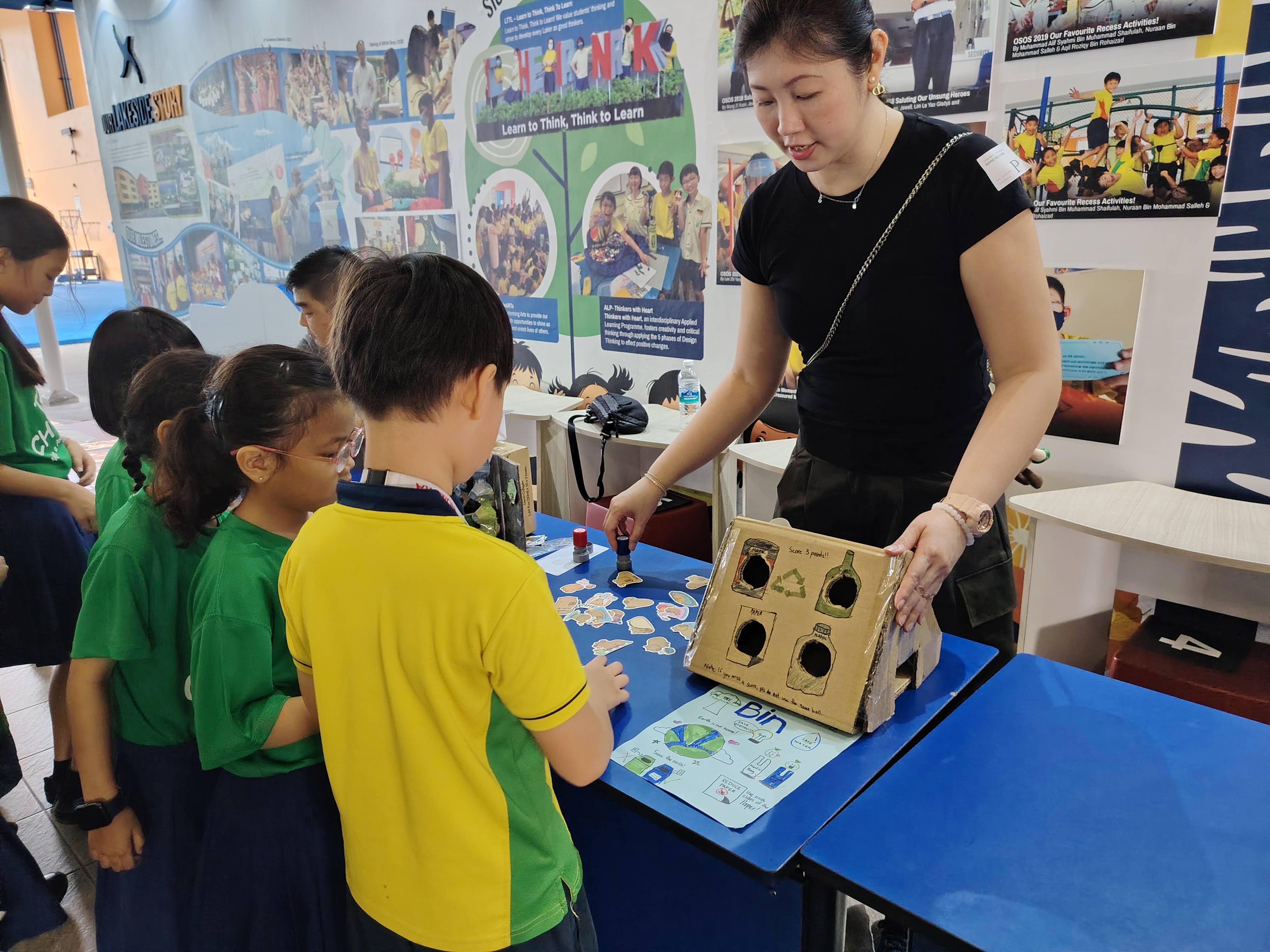 Students playing hands-on activities about going green at game booths and